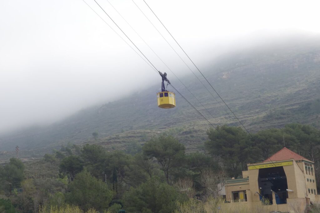 Montserrat cable car leaving the lower station on a misty day