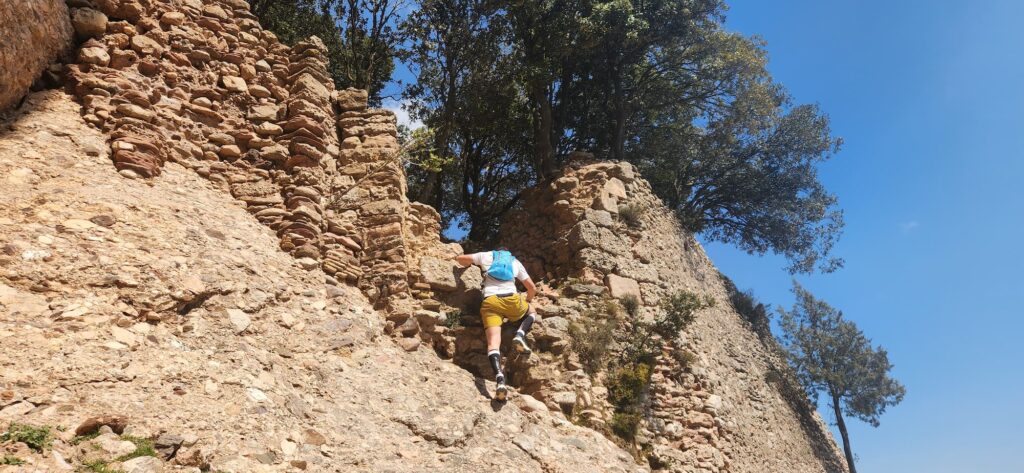 Climber accessing Sant Jaume hermitage Montserrat exposed rocky section technical hiking route