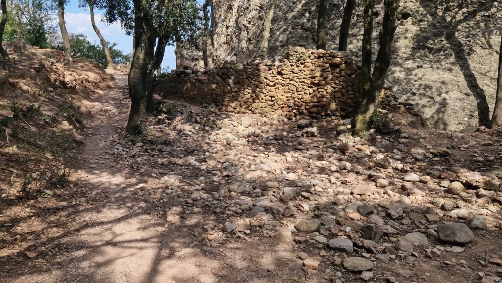 Santa Magdalena hermitage ruins in Montserrat with rocky path and exposed terrain