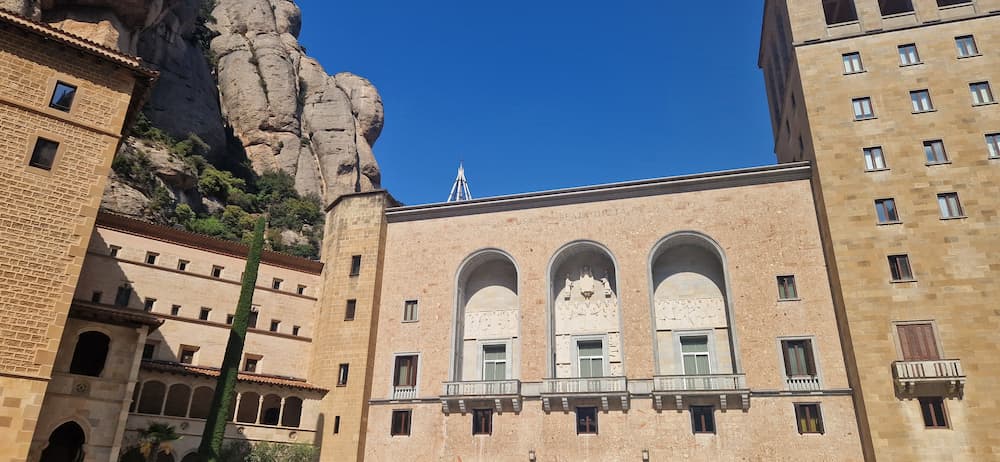 Main building of Montserrat Monastery in Catalonia surrounded by mountain landscape