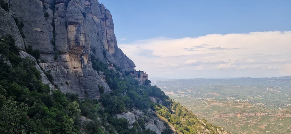 Santa Cova chapel built into the Montserrat cliffs with panoramic valley views