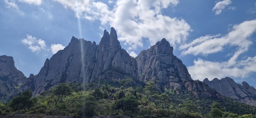 Sunny day in Montserrat with mountain peaks, blue sky and scattered clouds