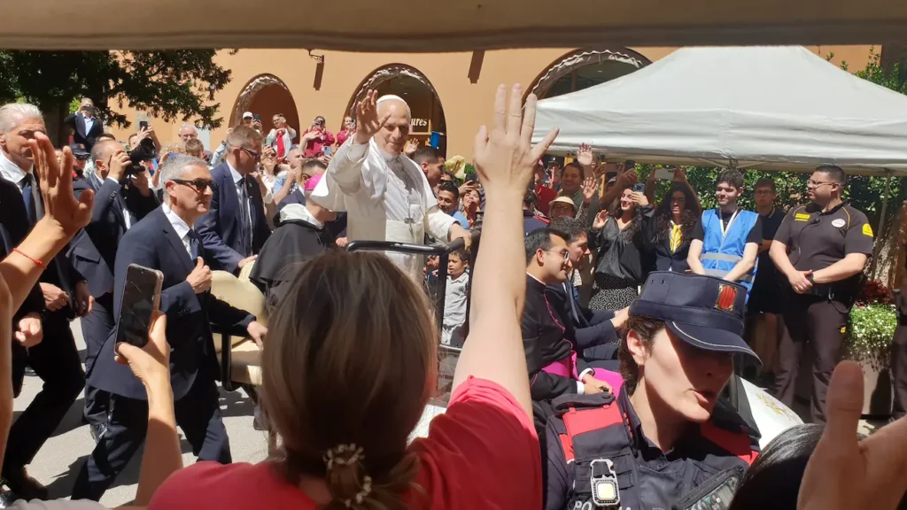 Close-up of Pope Leo XIV waving to pilgrims with raised hands during the Pope Leo XIV Montserrat visit