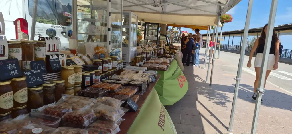 Jars of honey, nuts and nougat on a Cal Pujolet market stall at Montserrat