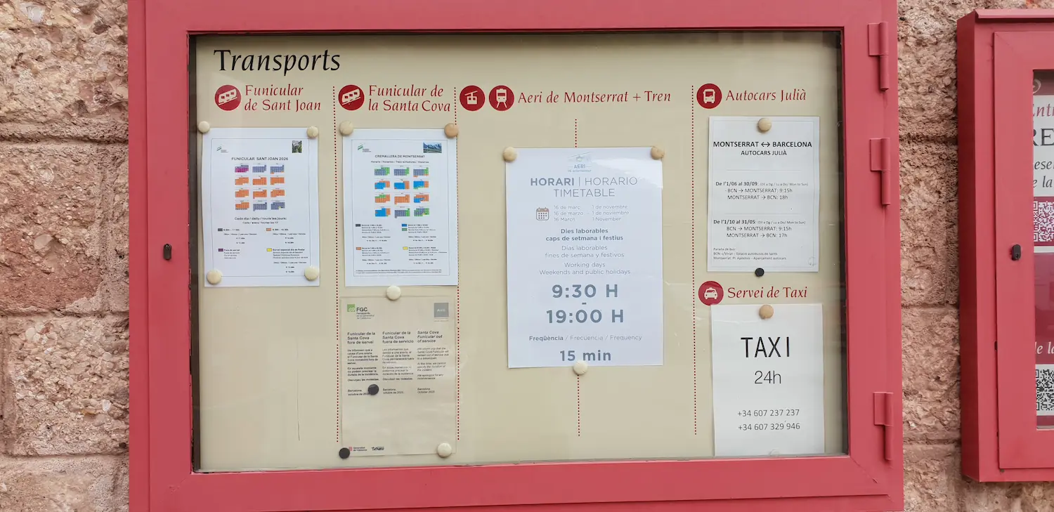 Transport noticeboard at Montserrat with funicular, cable car, Julià bus and taxi timetables